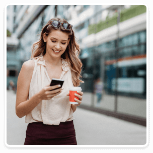 Woman walking down the street on her phone